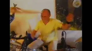 Phil Collins thrashing his drumkit