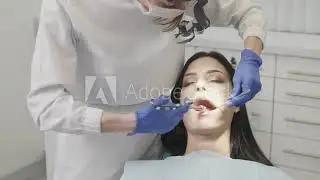 Dentist fixing cavity with a rubber dam