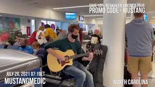 MustangMedic Vignettes Charlotte￼ North Carolina Airport a guy playing a guitar traveling back to DC