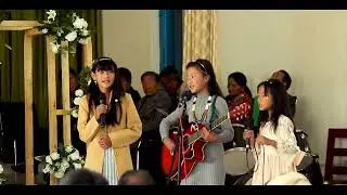 Three little girls singing beautiful song at the wedding ceremony.