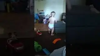 My son trying to fit his feet in his daddy's big shoes