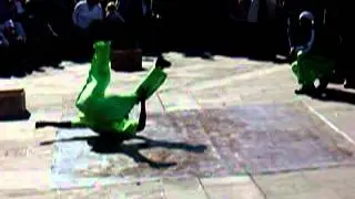 New Orleans break dancer removes jacket while performing the windmill dance move!