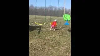Evelyn swings on her tummy at 22 months