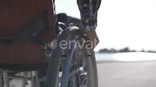 A Man in a Wheelchair Walks on the Waterfront | Stock Footage - Envato elements