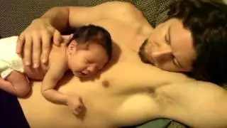 Newborn sleeping on his dad's chest.