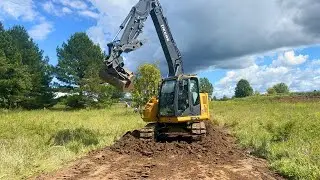 Fixing a flooded road with an excavator.