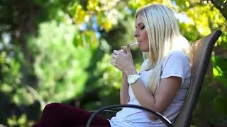 Woman smokes an all-white 100 outside