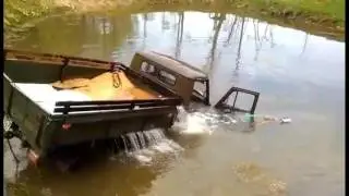 Soviet truck (UAZ) being pulled out of the lake after the accident