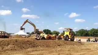Four wheel drive tractor pulling scraper pan, IH Dozer, Deere 230LC excavator