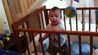 Tommy tries to climb out his bed