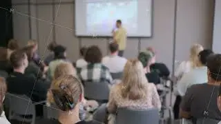 Audience attending a business presentation in a modern conference room