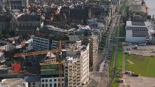 Aerial view of Antwerp, Belgium showcasing a construction site near the Scheldt River. The camera