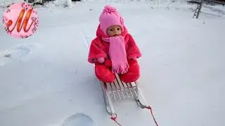 Baby Born in the new winter suit sledding on a bun with slides