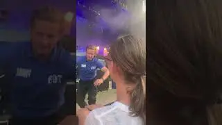 Security guard hands out cups of water at concert during London heat wave 