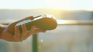 Close-up, man using smartphone cashless wallet NFC 