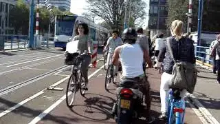 A Houseboat Moves on the Amstel in Amsterdam: Joy Ride Bike Tours