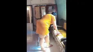 Mother cleans the table ini the room where the family mother's