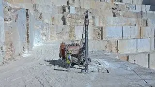 Commander Drill Rig at Work: Surface Drilling Action at the Colossal Danae Marble Quarry