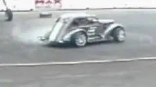 Guy tries to change a car tire while it's doing donuts