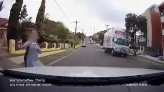 Video   Young girl distracted by headphones walks out in front of car