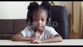 View From Webcam Little Cute Girl Child African American Kid Wears Headphones Speaks Into Microp...