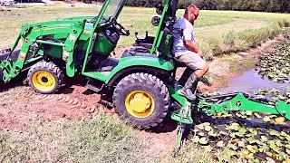 Dredging a Pond with a Tractor Backhoe - Digging Out Lily Pads