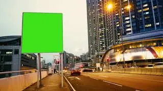 Chroma key billboard with a green screen on a evening streets of hong kong time lapse