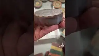 Cleaning the sharp edge of a round kaleidoscope soap bar with a soap router tool.