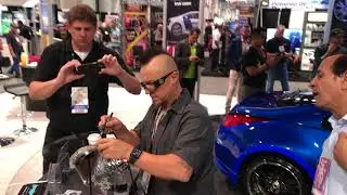 Ryno from west coast customs airbrushes over lumilor at SEMA 2017