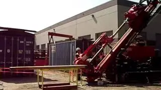 Hands-free rod handling developed for sonic drill rigs.