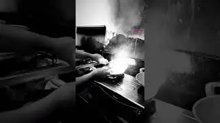 Chef is cooking and playing with the flame