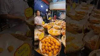2 very diligent little girls Helping a family sell fried chicken. Customers flock   in Thailand.