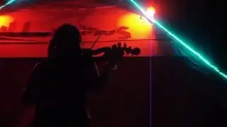 Tallulah playing electric violin at camp ILLUMINUS