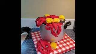 finishing details on the gravity defying Potluck Cake