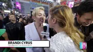Miley Cyrus Talks To Sister Brandi In An Exclusive AMA Red Carpet Interview
