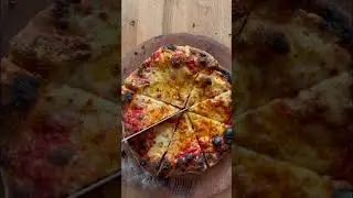 Slicing a cheese pizza made at home.
