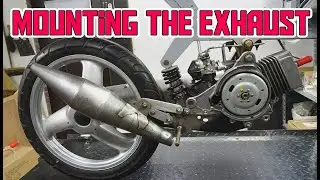 mounting the new exhaust on the Peugeot Fox Deluxe 50cc Racer