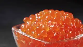 Red Caviar Rotated Over Black Background. Close-up Salmon Caviar Rotation. | Stock Footage - Env...
