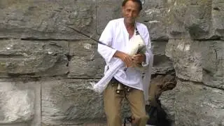Homeless guy with bagpipe shakes his bells