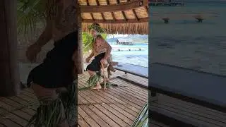 Opening a coconut on a pointy stick at Le Tahaa resort