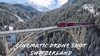 Scenic Drone shot of railroad bridge in beautiful Switzerland - winter wonderland