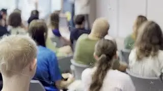 Audience attentively listening during an indoor seminar presentation