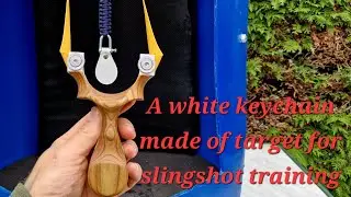 a white keychain made of target for slingshot training,  full butterfly slingshot shooting