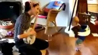 Baby dances to mom playing the banjo