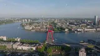 Aerial view of Rotterdam's skyline featuring Willemsbrug bridge over Nieuwe Maas river, capturing