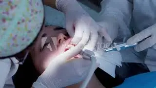 Girl at the dentist drilling her teeth