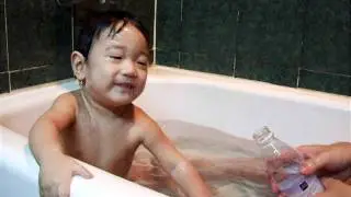 Seamus is taking a bath with dad.