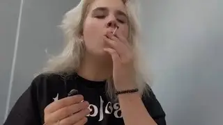 blondie girl smoking cigarette on balcony
