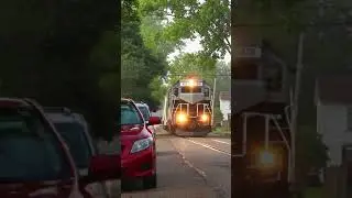 Train heads through neighborhood street #shorts