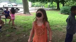 Carlee eating a hanging donut